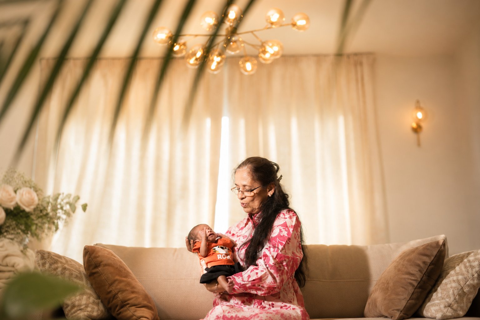 Grandmother holding newborn at home — home newborn session Dubai