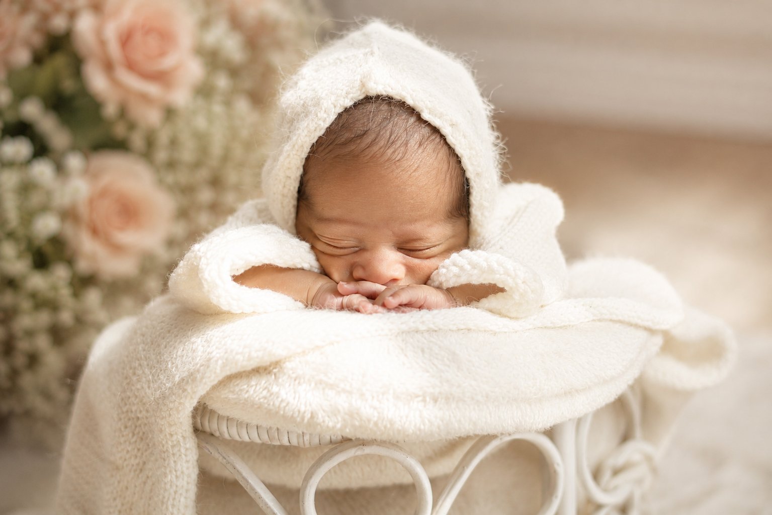 Newborn in heart chair setup — Dubai newborn studio photography