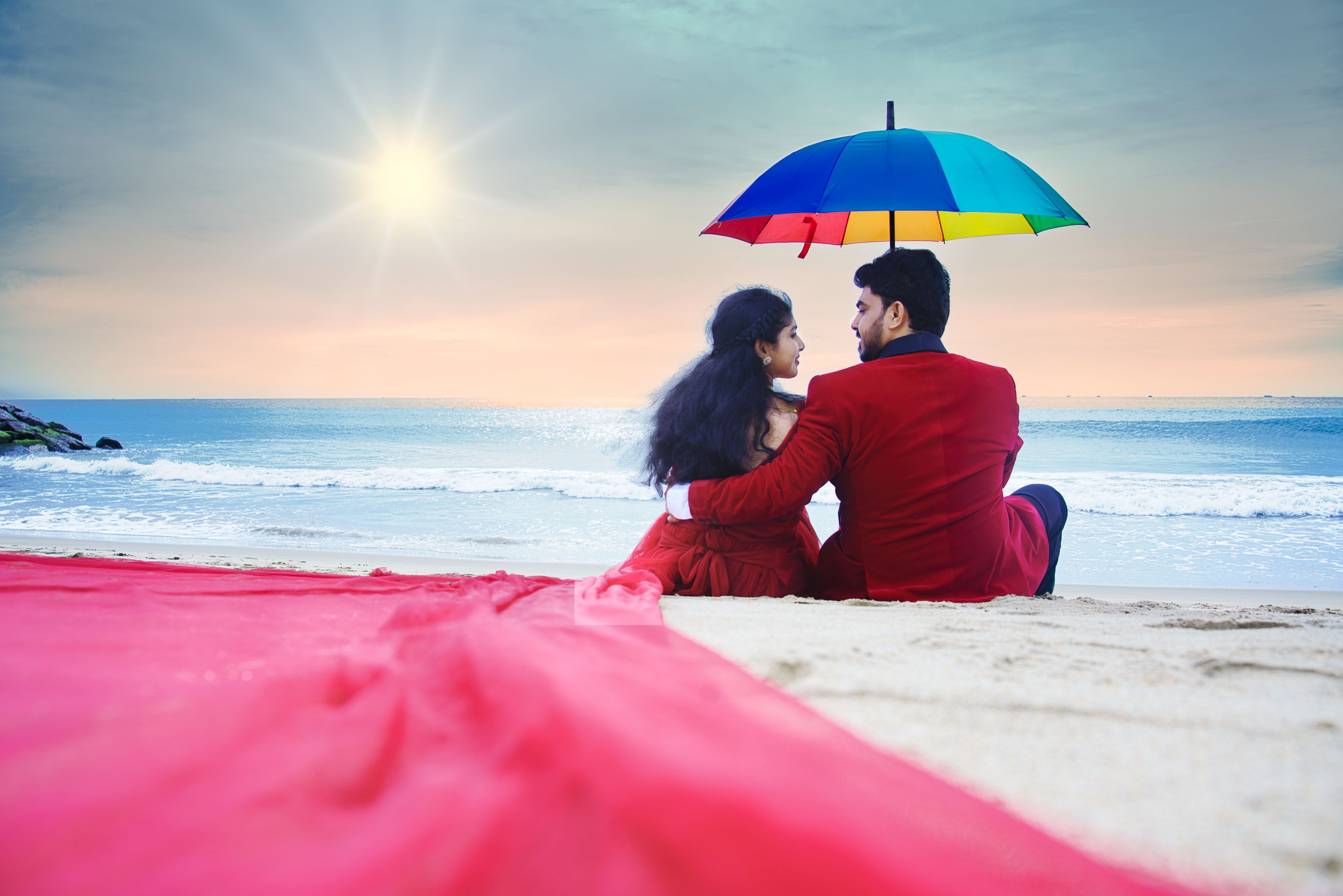 Couple colorful umbrella beach MG Photography